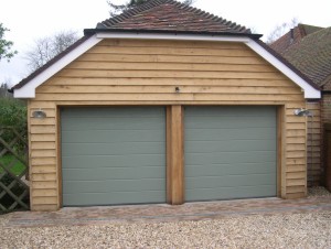 hormann ribbed sectional twin garage doors on gravel driveway with timber structure construction