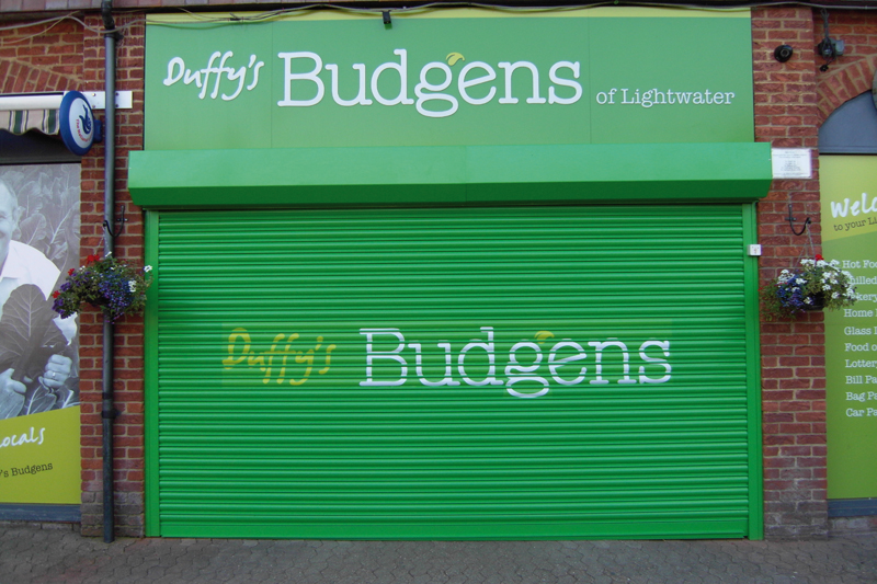 Security shop shutter with sign writing applied