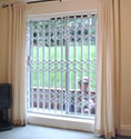 domestic retractable grille for security on a patio door