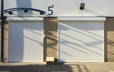 closed white security shutters over a door and window