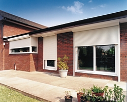 white electric security shutters on a bungalow