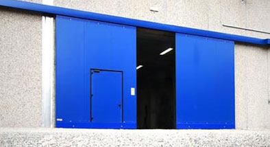 sliding steel door with pedestrian door inset